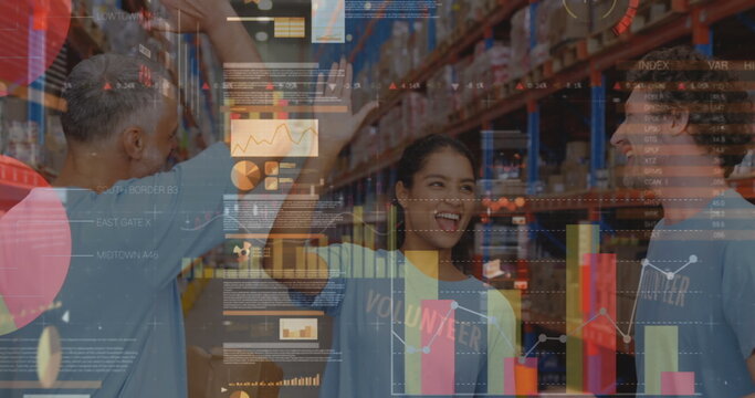Screens with data processing against male and female volunteers high fiving each other at warehouse