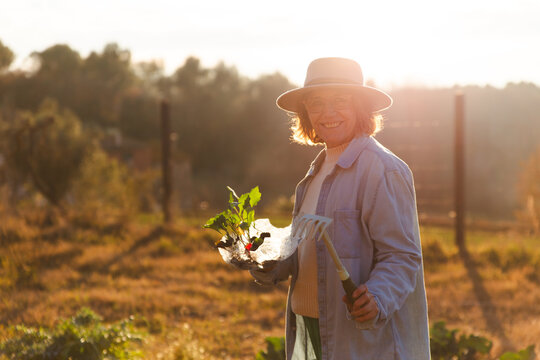 Woman gardening outdoors in the golden hour in Barcelona
