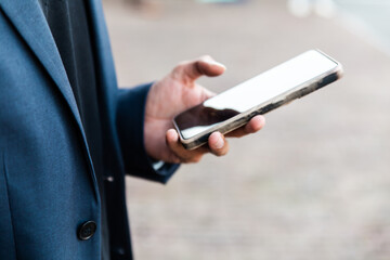 Indian man checking smartphone at a conference of AI in Amsterdam