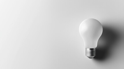 White light bulb on soft gray background	