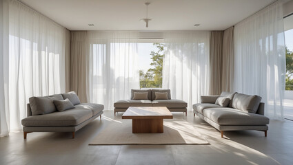 Fototapeta premium Serene minimalist living room bathed in sunlight, showcasing two plush grey sofas facing each other, creating an atmosphere of calm and relaxation with sheer curtains framing a tranquil outdoor view.