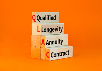 QLAC symbol. Concept word QLAC Qualified Longevity Annuity Contract on beautiful wooden blocks. Beautiful orange background. Business QLAC Qualified Longevity Annuity Contract concept. Copy space.