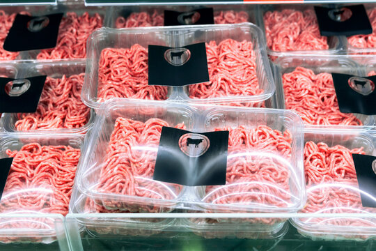 Packed minced meat trays on refrigerated supermarket shelf