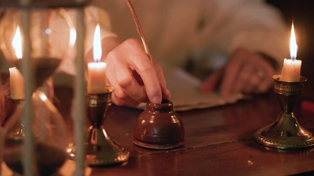 18th century man working at his desk using a quill pen