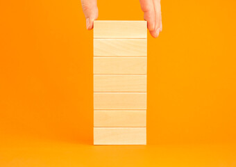 Man's hand stacking blank wooden blocks. Business development concept. Solution, solve problem,...