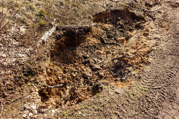 Rain washout of sandy soil on a slope, soil erosion