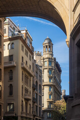 Barcelona, Spain - March 11, 2023, Hotel Colonial Barcelona in the arch, Architectural view of a European city street through an archway