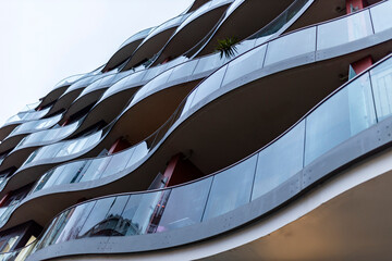 Modern residential building with curved balconies and glass railings