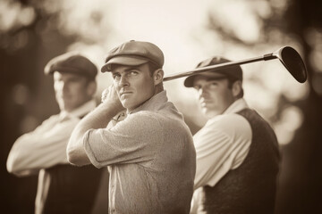 Golfers wearing vintage clothes are swinging on the golf course