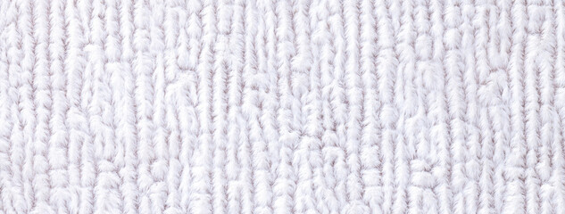 Texture of fluffy woolen white textile background from soft fleecy material, macro. Structure of fabric with pattern.