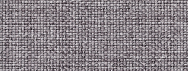Texture dark gray background from woven textile material with wicker pattern, macro. Structure grey vintage fabric cloth