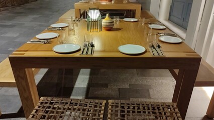 Elegant dining setup with wooden table and simple decoration for an evening gathering