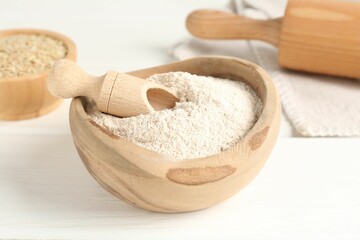 Brown rice and flour on white table, closeup