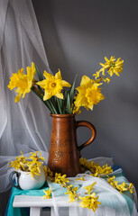 A stunning display of vibrant yellow flowers beautifully arranged in a vintage pitcher