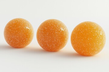 Three Orange Candies Covered in Sugar Crystals on White Background Still Life
