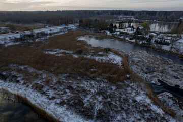 aerial view of early winter with river, snow covered fields