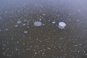 Weathered frozen water ice surface candelized with cracks and air bubbles