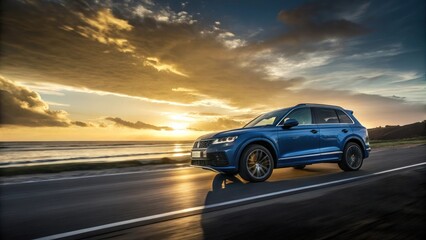 Sleek blue SUV, dramatic sunset, golden sky, coastal road