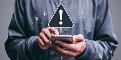 Person using smartphone, multiple warning signs appear above, symbolizing online security, alert, notification, or error message concept