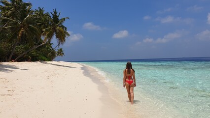 Woman in Red Bikini Walking on Paradise Beach in Maldives