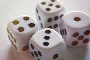Four dices on a white table close-up