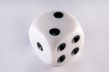 Single dice on a white table