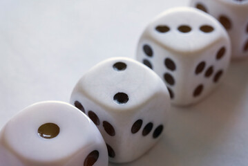 Four dices on a white table close-up
