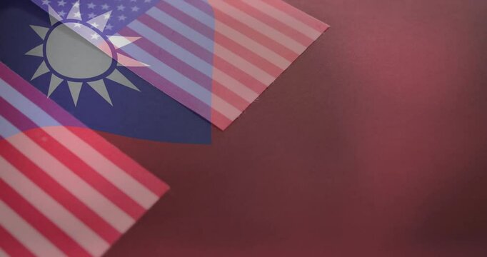 Overlapping Taiwan and United States flags symbolizing diplomacy on red background