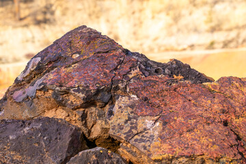 Eroded bauxite rock formation with bright orange colors in an abandoned bauxite mine