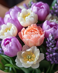 Obraz premium Elegant floral arrangement featuring tulips and other blossoms in soft pastel colors for spring celebration