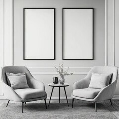 Two grey armchairs facing each other with a small round table and two blank frames on a wall.