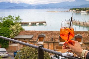 Aperol Spritz with a view of Lake Garda.