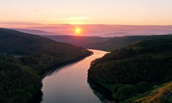 A view from a drone of a beautiful sunset in the valleys with the river
