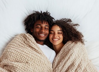 Cozy Couple Smiling Under Blanket in Bed Enjoying Relaxing Moment