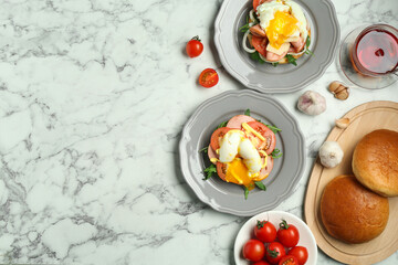 Flat lay composition with tasty brunch on white marble table. Space for text