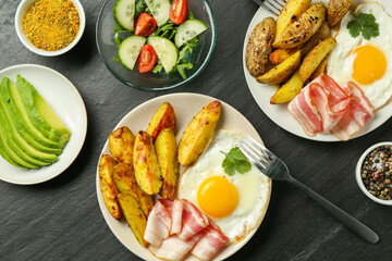 Flat lay composition with tasty brunch served on dark textured table