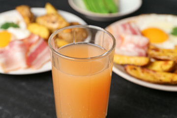 Tasty brunch. Refreshing drink and dishes on dark table, closeup