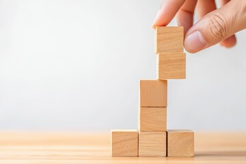 Wooden blocks stacked by hand in creative arrangement