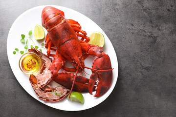 Delicious boiled lobster served on grey table, top view. Space for text