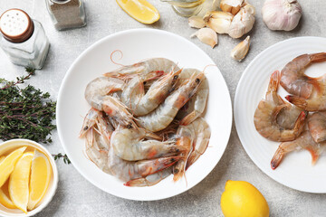 Fresh raw shrimps and spices on grey table, flat lay