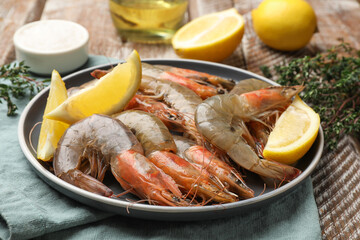 Fresh raw shrimps and spices on wooden table, closeup