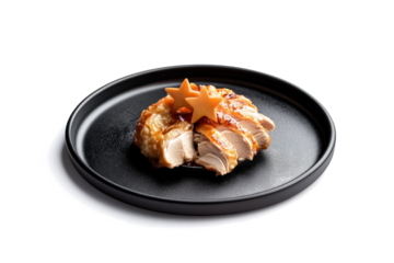 a black plate with a piece of chicken on it cutout and isolated on transparent background 