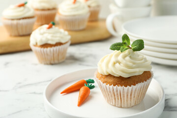 Delicious carrot cupcake with mint on white marble table, closeup