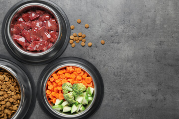 Dry pet food and natural products on grey table, top view. Space for text