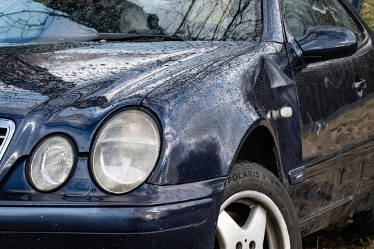Round headlamps of Mercedes-Benz CLK Coupe W208 car with damaged fender