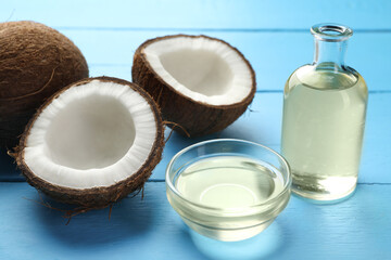 Organic coconut cooking oil and fresh fruits on light blue wooden table, closeup