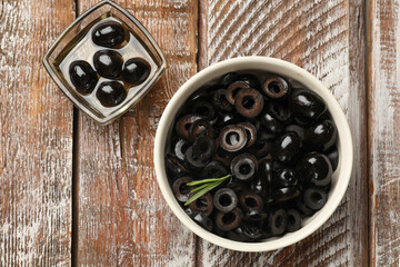 Delicious marinated olive rings on wooden table, flat lay