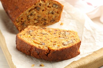 Cut homemade carrot cake with nuts on table, closeup