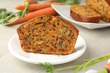 Homemade carrot cake with nuts and vegetables on light grey table, closeup
