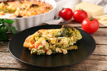 Tasty vegetable casserole on wooden table, closeup